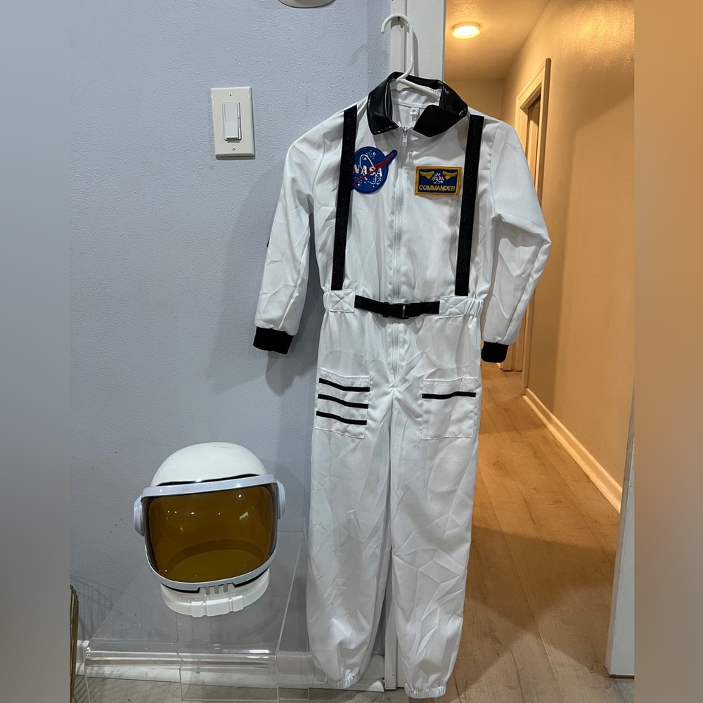 Astronaut costume. Includes helmet and astronaut suit. Boys size 10-12.